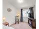 Main bedroom with ceiling fan, natural light, and television on dresser at 130 Park Ridge Ln, Henderson, NV 89002