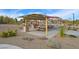 Community picnic area featuring covered picnic tables and barbeque grills, surrounded by desert landscaping at 130 Park Ridge Ln, Henderson, NV 89002