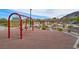 Community playground featuring swings, a picnic shelter, and a grill for gatherings at 130 Park Ridge Ln, Henderson, NV 89002