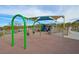 Community playground featuring swings, a play structure, and shaded seating area for residents to enjoy at 130 Park Ridge Ln, Henderson, NV 89002