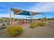 Community playground area with slides and swings under a shaded structure at 130 Park Ridge Ln, Henderson, NV 89002