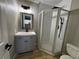 Bathroom features corner shower, modern vanity and wood-look flooring at 150 Greenbriar Townhouse Way, Las Vegas, NV 89121