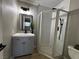 Updated bathroom features a modern vanity and a glass-enclosed shower with a sleek, black showerhead and fixtures at 150 Greenbriar Townhouse Way, Las Vegas, NV 89121