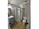 Bathroom featuring a glass-enclosed shower, toilet, and modern vanity with dark fixtures at 150 Greenbriar Townhouse Way, Las Vegas, NV 89121