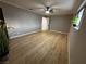 Spacious bedroom featuring new wood floors, neutral paint, ceiling fan and base board trim at 150 Greenbriar Townhouse Way, Las Vegas, NV 89121