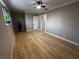 Spacious bedroom featuring new wood floors, neutral paint, ceiling fan and base board trim at 150 Greenbriar Townhouse Way, Las Vegas, NV 89121