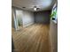 Spacious bedroom with wood-look flooring, a ceiling fan, and an en-suite bathroom at 150 Greenbriar Townhouse Way, Las Vegas, NV 89121