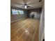 This bedroom offers wood floors, neutral paint, a ceiling fan, and natural light at 150 Greenbriar Townhouse Way, Las Vegas, NV 89121