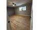 Bedroom with wood-look flooring, ceiling fan, natural light, and modern color scheme at 150 Greenbriar Townhouse Way, Las Vegas, NV 89121
