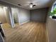 Bedroom featuring wood look flooring, neutral paint, and a doorway to an ensuite bathroom at 150 Greenbriar Townhouse Way, Las Vegas, NV 89121