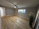 Bright bedroom featuring new wood floors, neutral paint, ceiling fan, and base board trim at 150 Greenbriar Townhouse Way, Las Vegas, NV 89121