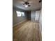 Bedroom showcasing wood-look flooring, ceiling fan, natural light, and modern color scheme at 150 Greenbriar Townhouse Way, Las Vegas, NV 89121
