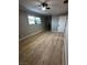 This spacious bedroom has wood floors, natural light, neutral paint, and white trim at 150 Greenbriar Townhouse Way, Las Vegas, NV 89121