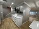 Dining area with white cabinets, quartz countertop, dark shelving and wood-look flooring at 150 Greenbriar Townhouse Way, Las Vegas, NV 89121