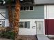 Charming home featuring colorful siding and mature palm trees in the front yard at 150 Greenbriar Townhouse Way, Las Vegas, NV 89121
