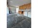 Large garage featuring upper cabinets, laundry, parking, and additional storage at 150 Greenbriar Townhouse Way, Las Vegas, NV 89121