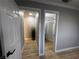 Hallway featuring new wood floors, neutral paint and trim leading to bedroom and bath at 150 Greenbriar Townhouse Way, Las Vegas, NV 89121