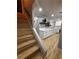 Hallway featuring staircase, white cabinets, quartz countertops, and open access to other rooms at 150 Greenbriar Townhouse Way, Las Vegas, NV 89121