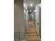 Hallway featuring light wood floors and white doors at 150 Greenbriar Townhouse Way, Las Vegas, NV 89121