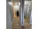 Hallway featuring wood floors, neutral paint, and white doors at 150 Greenbriar Townhouse Way, Las Vegas, NV 89121