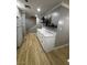 Kitchen featuring white cabinets, quartz countertops, and modern shelving at 150 Greenbriar Townhouse Way, Las Vegas, NV 89121