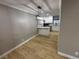 Eat-in kitchen area features modern pendant lighting, white cabinets and wood-look floors at 150 Greenbriar Townhouse Way, Las Vegas, NV 89121