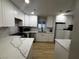 Updated kitchen with white cabinets, stainless steel appliances, and quartz countertops at 150 Greenbriar Townhouse Way, Las Vegas, NV 89121