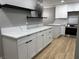 Beautiful kitchen featuring quartz countertops, modern cabinets, and new floors at 150 Greenbriar Townhouse Way, Las Vegas, NV 89121