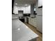 Remodeled kitchen with stainless steel appliances, stone countertops, and modern cabinetry at 150 Greenbriar Townhouse Way, Las Vegas, NV 89121