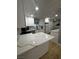 Kitchen featuring white cabinets, quartz countertops, and stainless appliances at 150 Greenbriar Townhouse Way, Las Vegas, NV 89121
