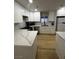 Modern kitchen featuring white cabinets, quartz countertops, and stainless appliances at 150 Greenbriar Townhouse Way, Las Vegas, NV 89121