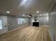 Bright living room with new light wood-look flooring, a fireplace, ceiling fan, and plenty of natural light at 150 Greenbriar Townhouse Way, Las Vegas, NV 89121