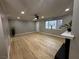 Open living room with new flooring, modern ceiling fan, and natural light with view of plants at 150 Greenbriar Townhouse Way, Las Vegas, NV 89121