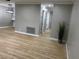 Inviting living room featuring neutral paint, stylish light fixture, and light wood-look flooring at 150 Greenbriar Townhouse Way, Las Vegas, NV 89121