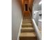 Staircase with wood-look steps and white railing, connecting different levels of the home at 150 Greenbriar Townhouse Way, Las Vegas, NV 89121