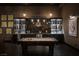 Spacious bar area with a pool table, custom shelving, and unique design elements at 1683 Tangiers Dr, Henderson, NV 89012