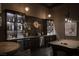 Elegant bar area with custom cabinetry, stylish lighting, and a pool table for entertaining at 1683 Tangiers Dr, Henderson, NV 89012
