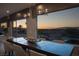 Dining room with large windows offering panoramic sunset views of the mountains and surrounding landscape at 1683 Tangiers Dr, Henderson, NV 89012