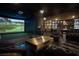 A great game room with a golf simulator, a bar, and refined decor at 1683 Tangiers Dr, Henderson, NV 89012