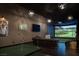A fantastic game room featuring a golf simulator, putting green, and comfortable seating at 1683 Tangiers Dr, Henderson, NV 89012