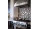 A stovetop with a vent hood and decorative backsplash at 1683 Tangiers Dr, Henderson, NV 89012