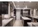 Modern kitchen with stainless steel appliances, dark wood cabinets, and light countertops at 1683 Tangiers Dr, Henderson, NV 89012