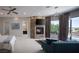 Bright main bedroom with a fireplace, comfortable seating, and access to a patio and pool at 1683 Tangiers Dr, Henderson, NV 89012