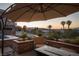 A relaxing outdoor seating area with an umbrella, surrounded by desert landscaping at 1683 Tangiers Dr, Henderson, NV 89012