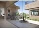 This patio offers an outdoor dining area with a fireplace and beautiful landscaping at 1683 Tangiers Dr, Henderson, NV 89012