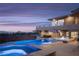 Backyard pool with a jacuzzi and lounge chairs with a view of mountains and a cloudy sky at 1683 Tangiers Dr, Henderson, NV 89012