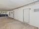 A covered back porch with concrete floor, white walls, and white security doors offers shelter and access to the home's exterior at 1704 S 8Th St, Las Vegas, NV 89104