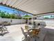 The backyard features a covered patio with table, chairs, and a BBQ at 1704 S 8Th St, Las Vegas, NV 89104