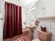 This bathroom features a pink theme, shower with curtain, and vanity sink at 1704 S 8Th St, Las Vegas, NV 89104