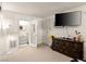 The bedroom has a mounted television, dresser, and a doorway to the on-suite bathroom at 1704 S 8Th St, Las Vegas, NV 89104